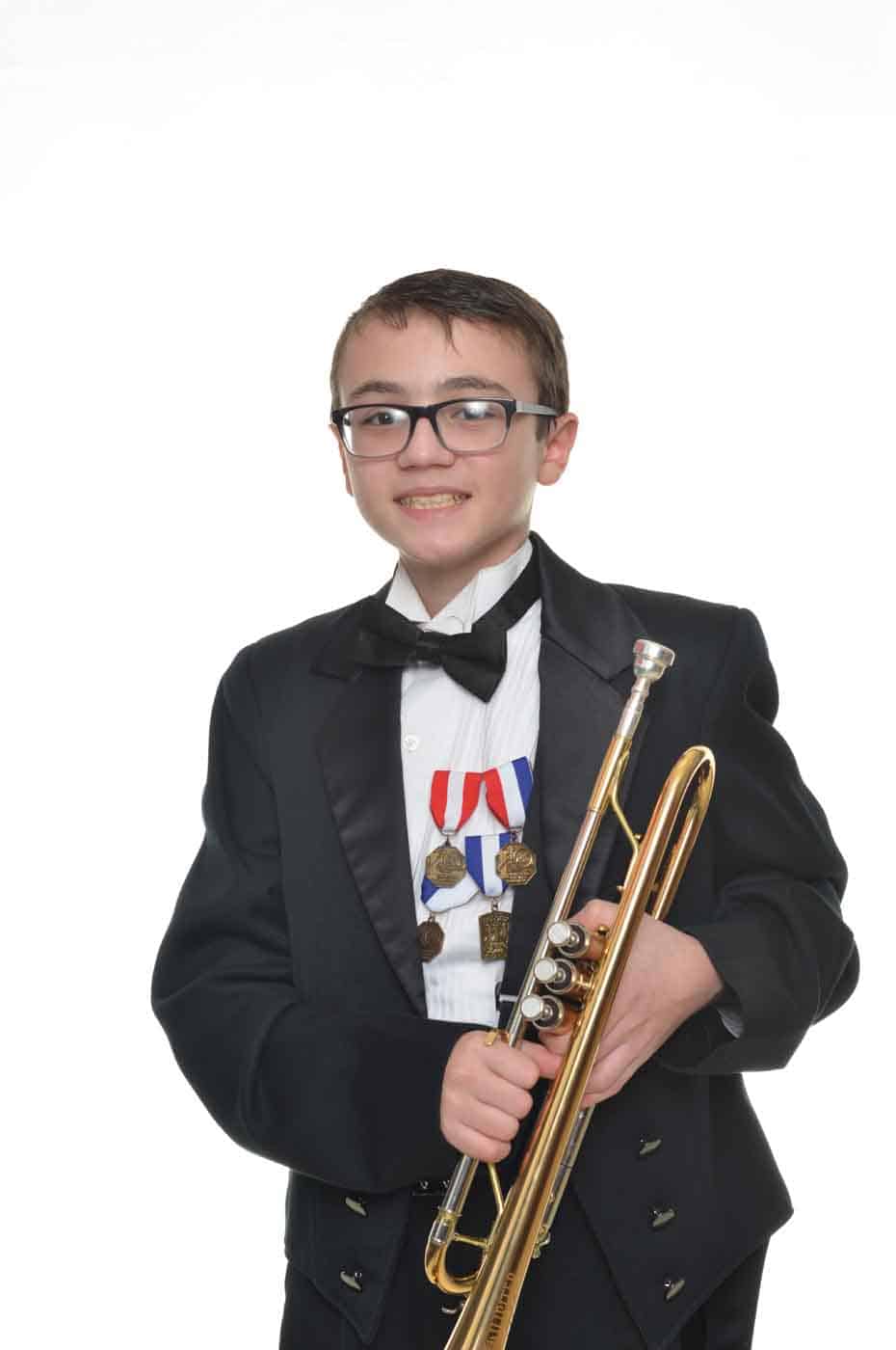 Young boy in suit with brass instrument