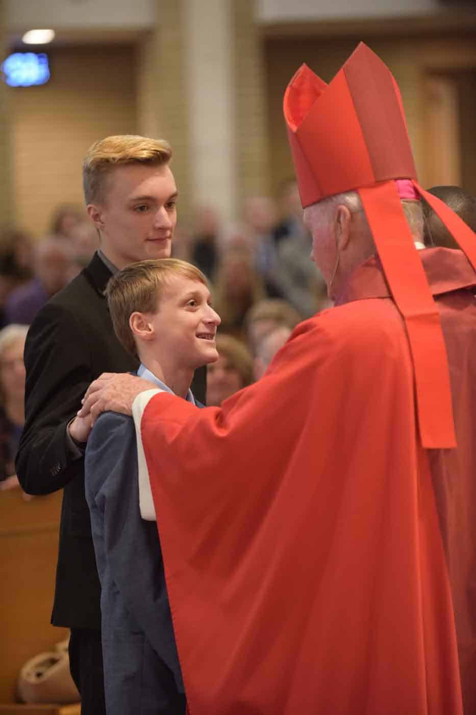 Young man, father and priest Confirmation photo