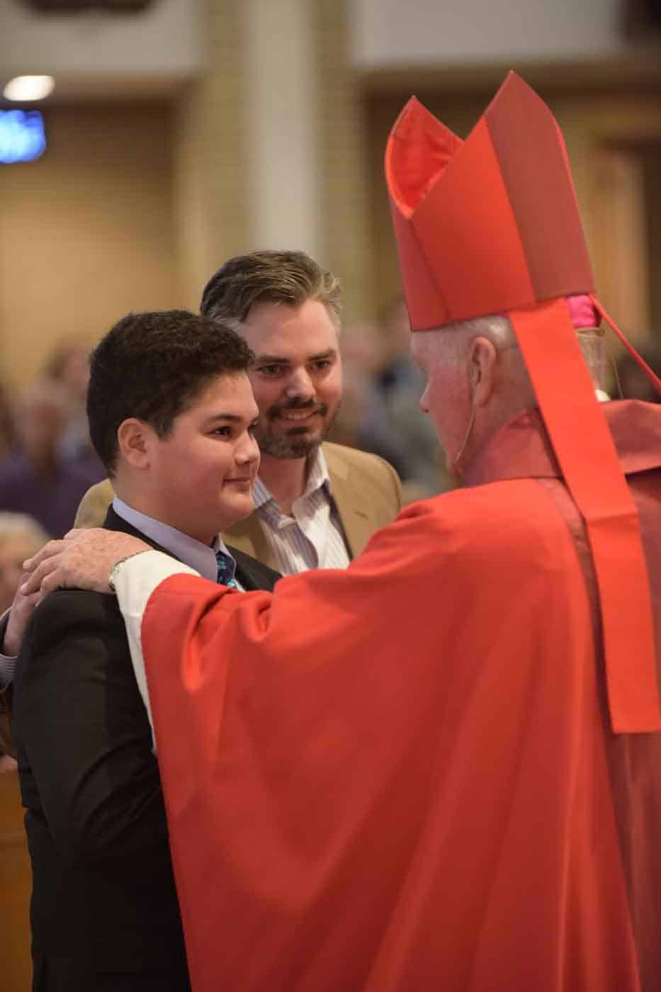 Young man, father and priest Confirmation photo