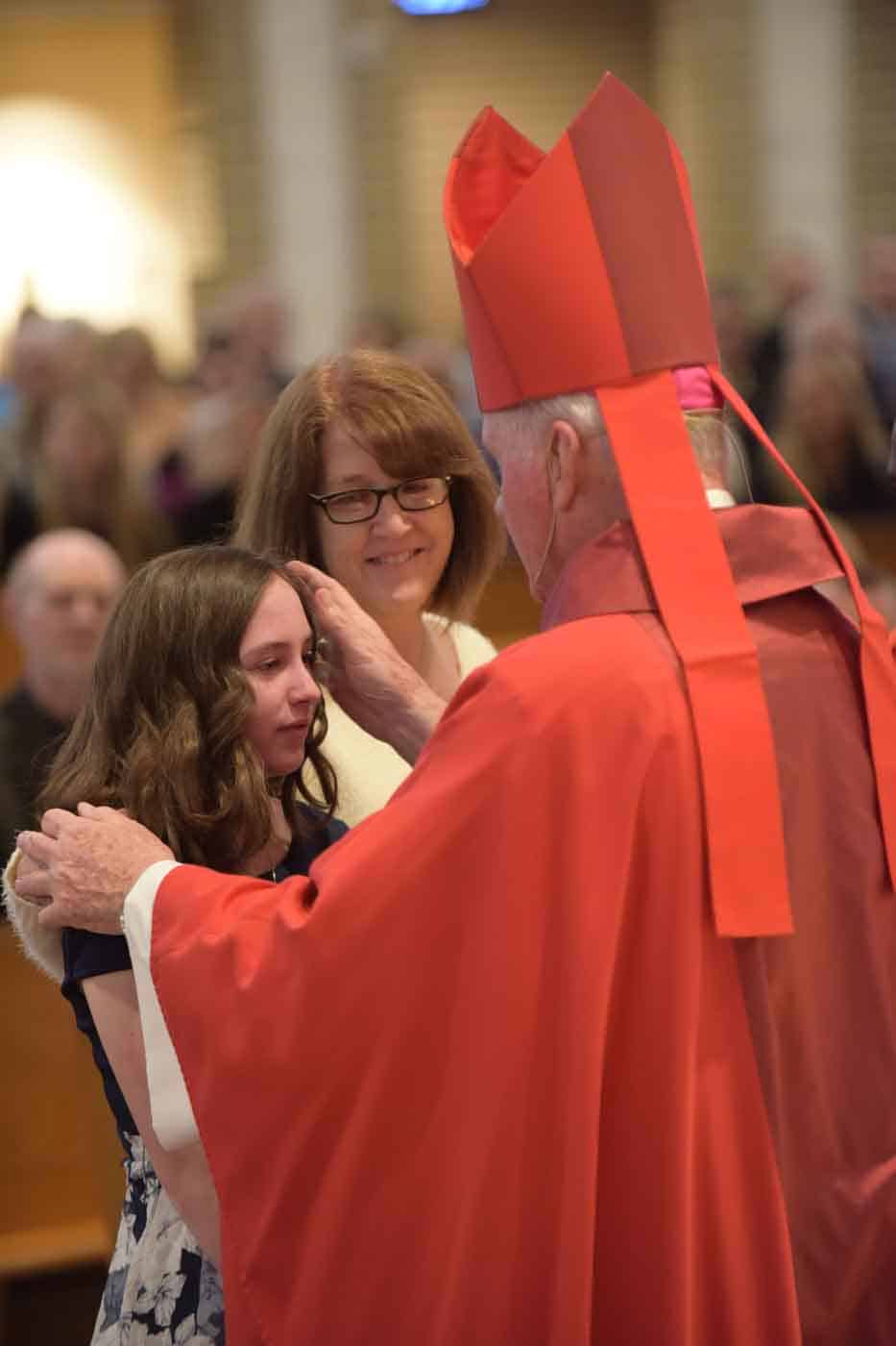 Young lady, mother and priest Confirmation photo