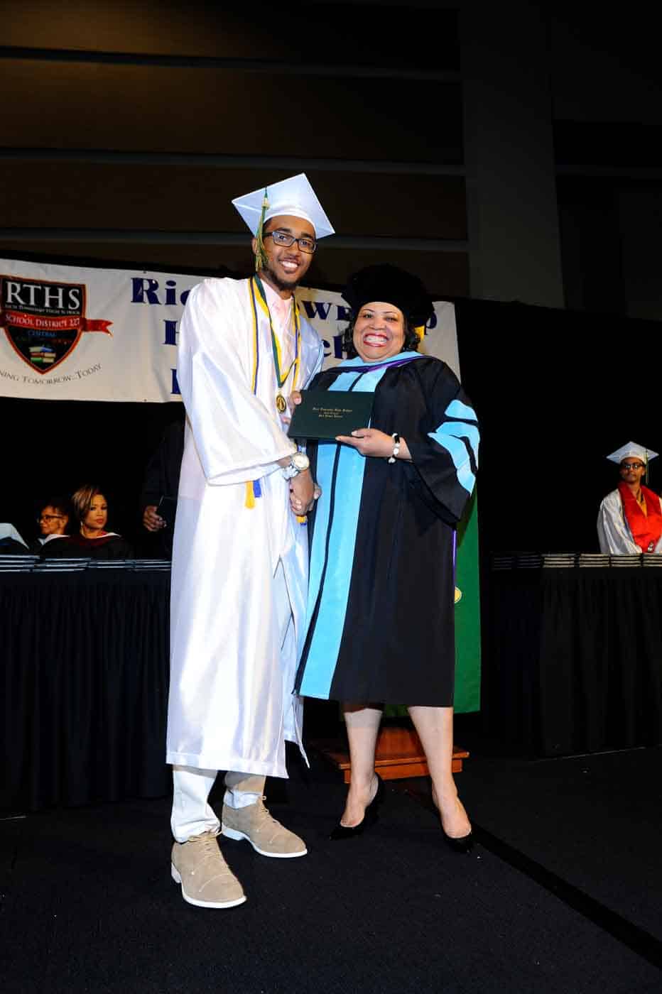 guy and lady posing with diplomas