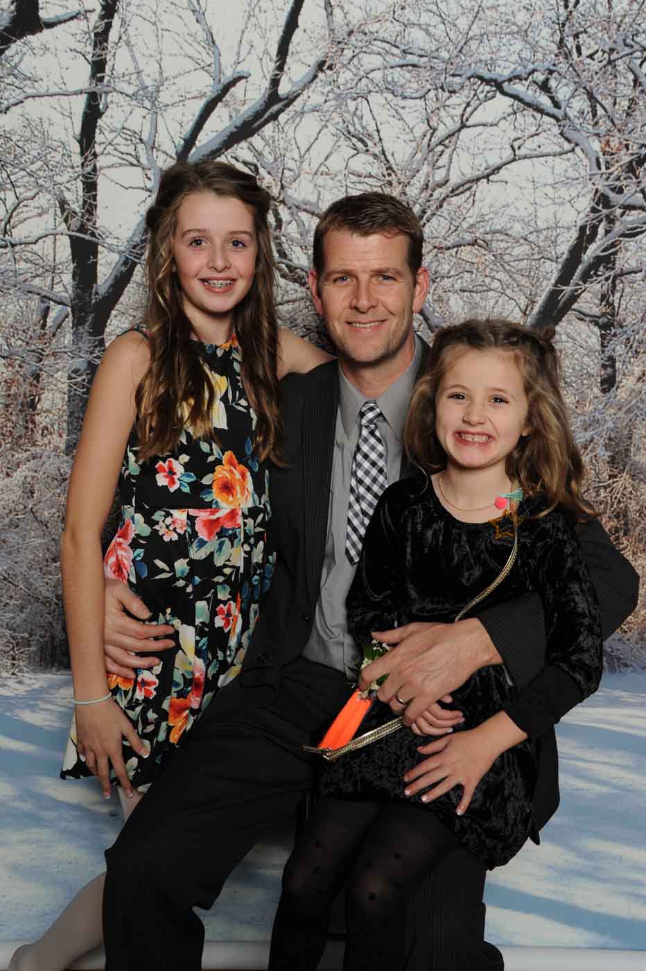 Man with 2 daughters posing