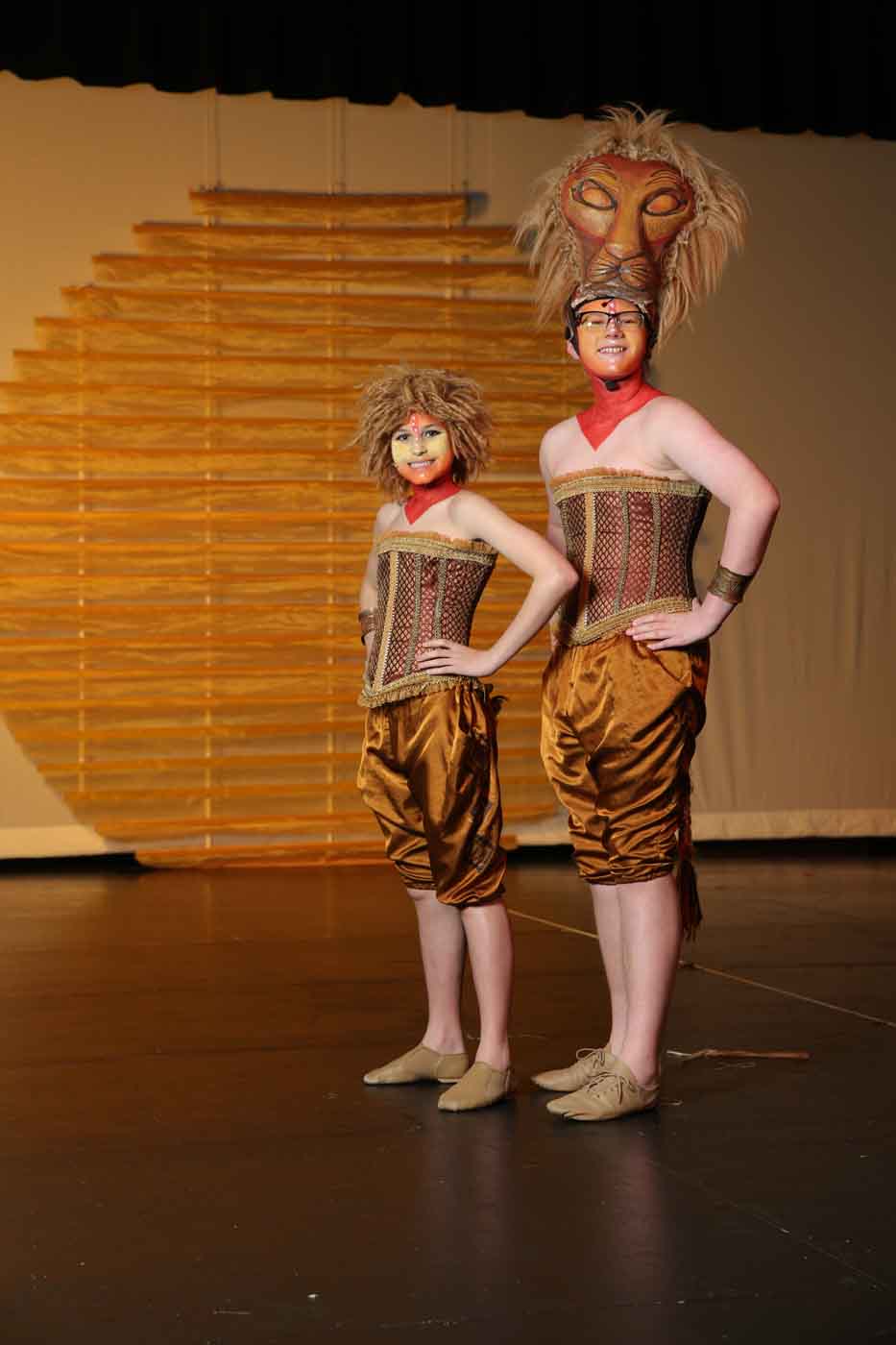 2 people posing in lion king costumes for school play