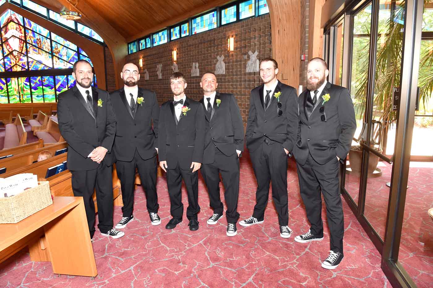 Groom and 5 groomsmen posing in church